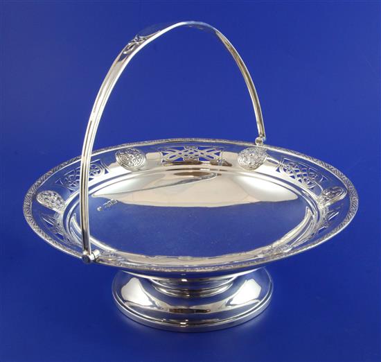 An Edwardian Arts & Crafts silver cake basket by Goldsmiths & Silversmiths Co Ltd, 24.5 oz.